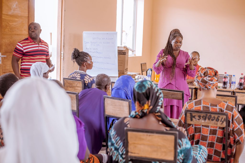 Deborah Elias Ijiko (standing in the middle) while giving a presentation to parents